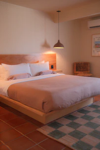 Cozy hotel bedroom with a large bed and warm lighting.