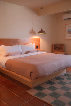Cozy hotel bedroom with a large bed and warm lighting.