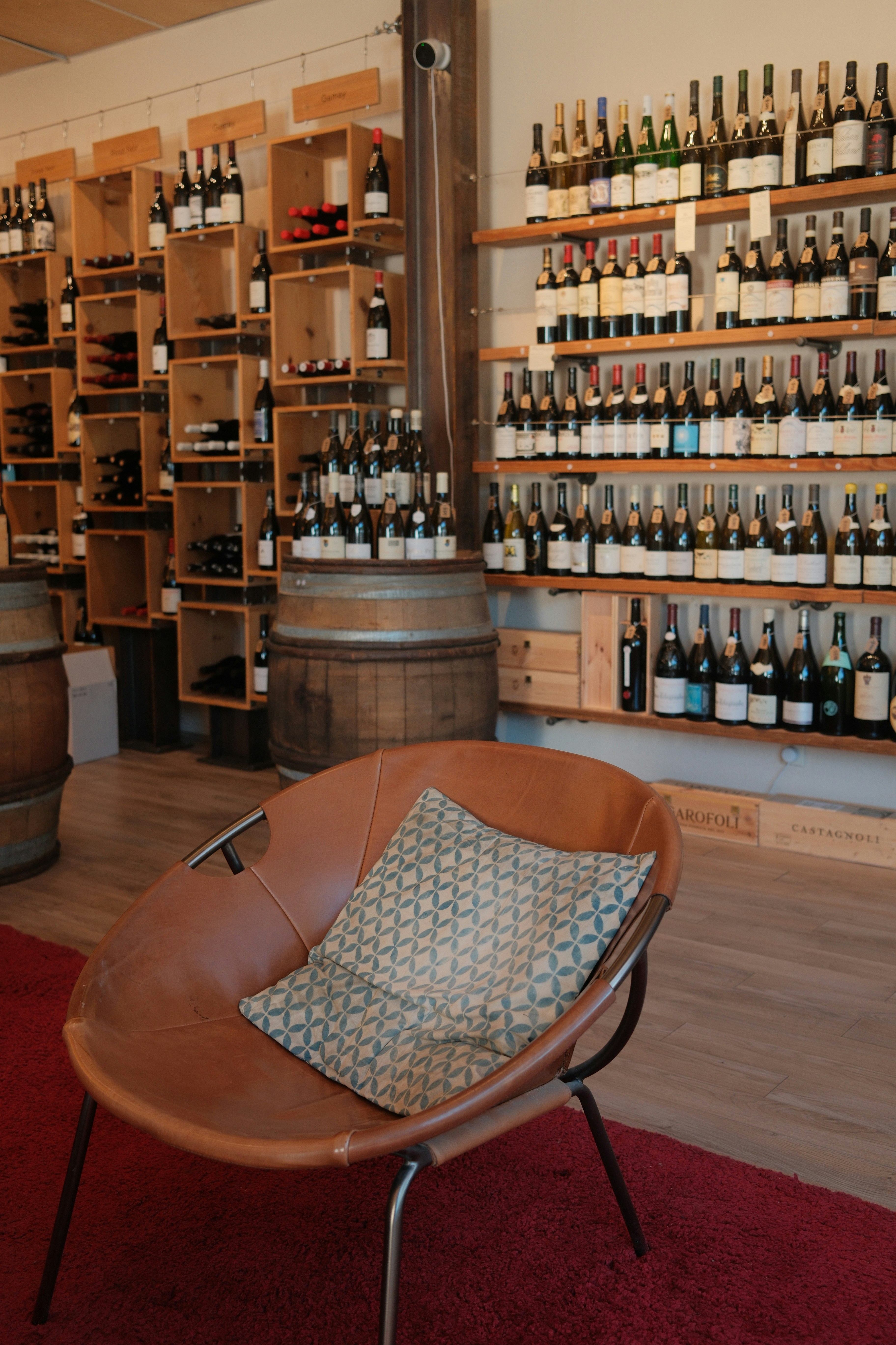 Leather chair in a wine shop with shelves of wine