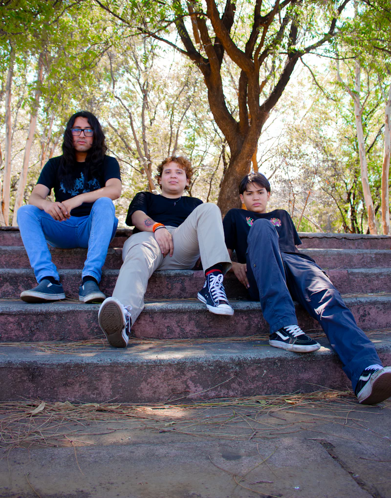 Three teens sitting together on outdoor stairs