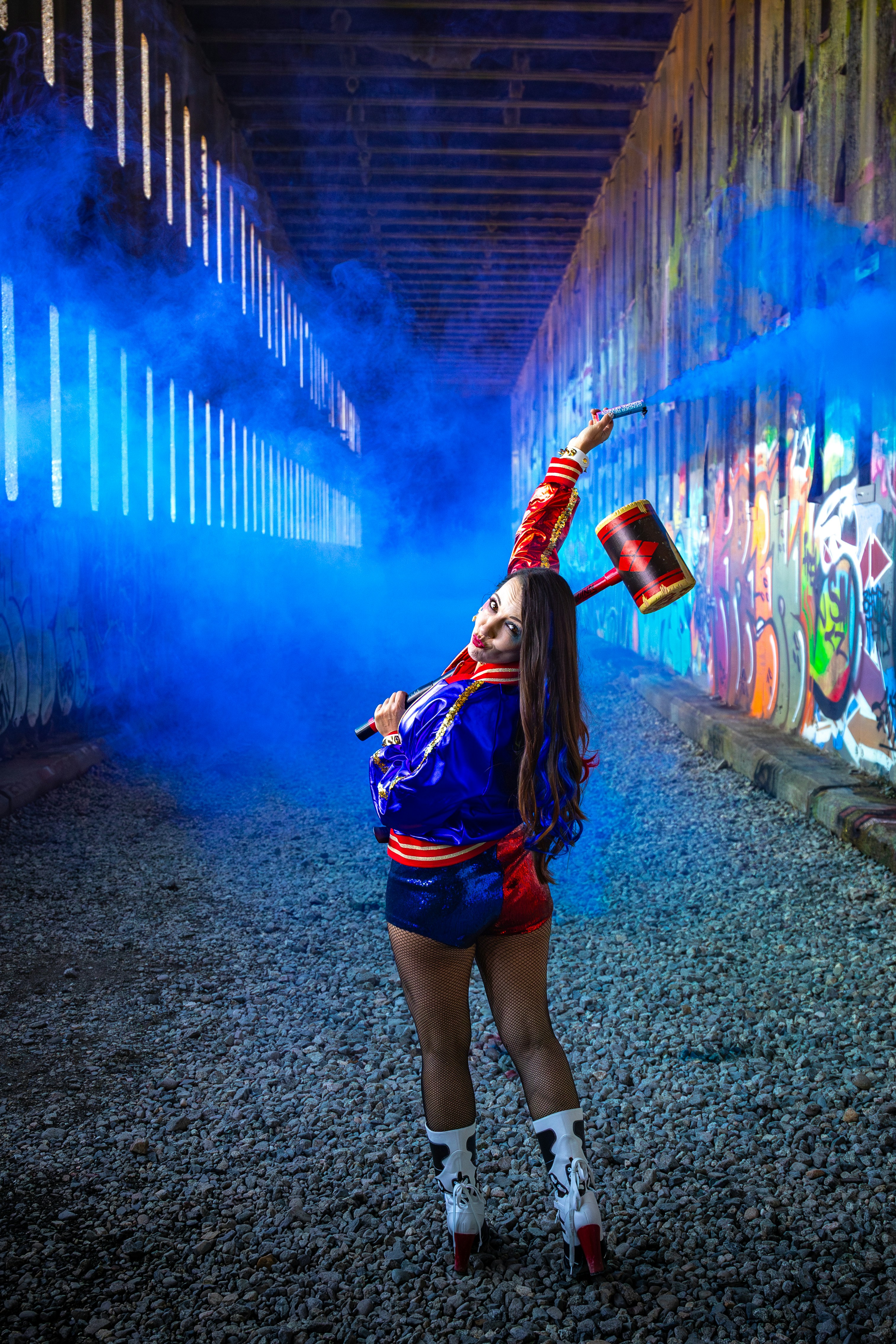 Woman in colorful outfit with hammer in tunnel
