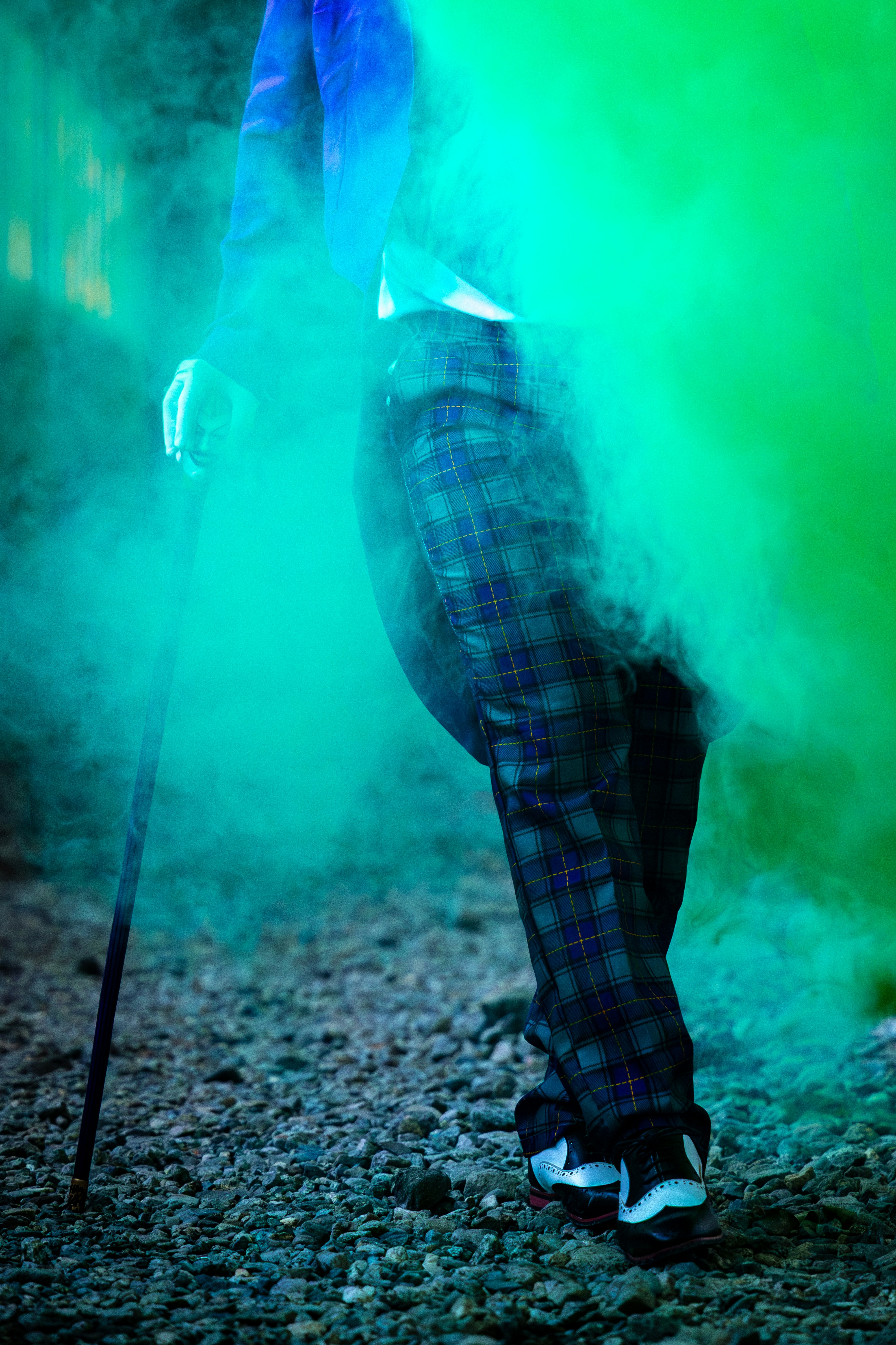 Person with cane surrounded by green smoke