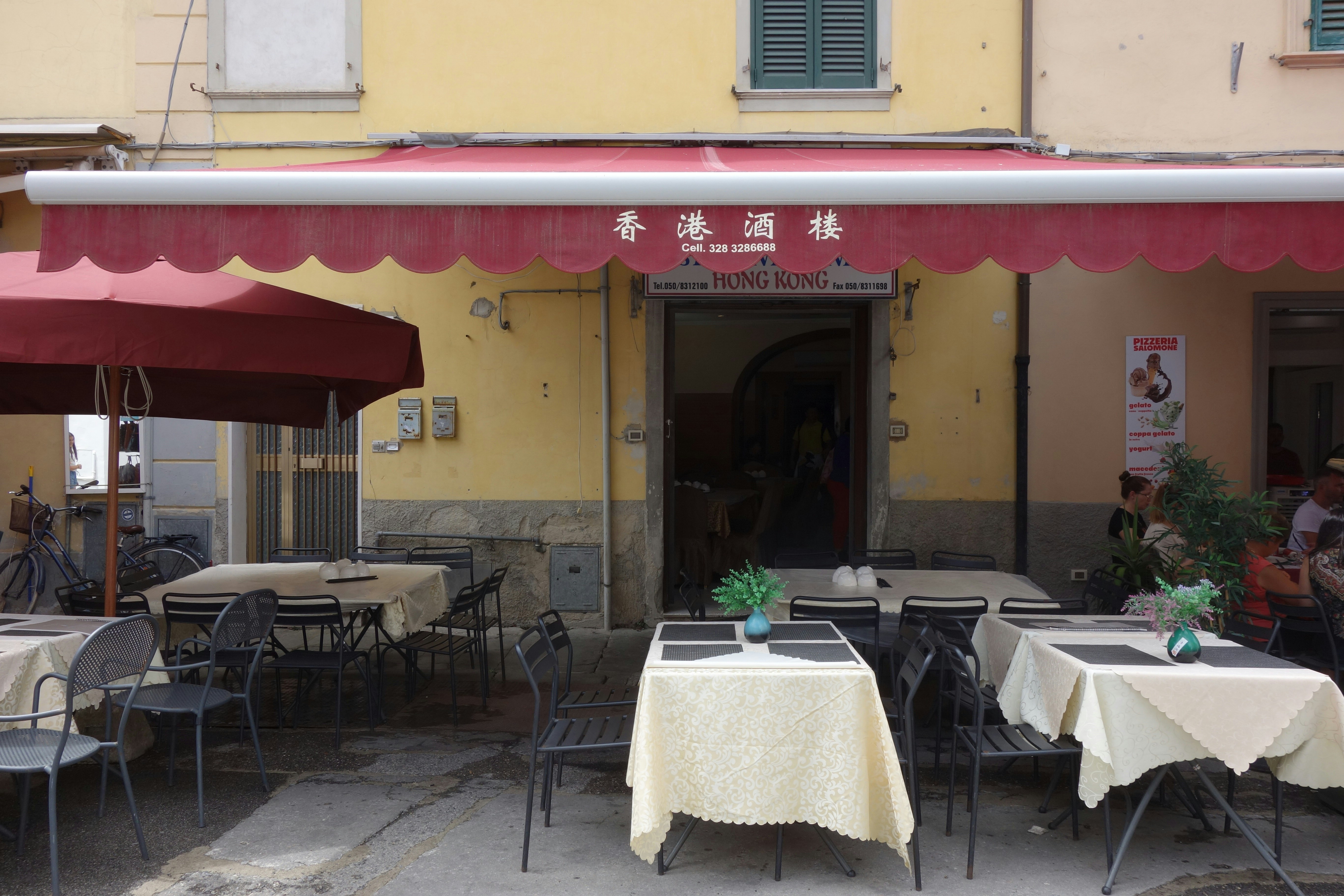 outdoor tables at yellow building