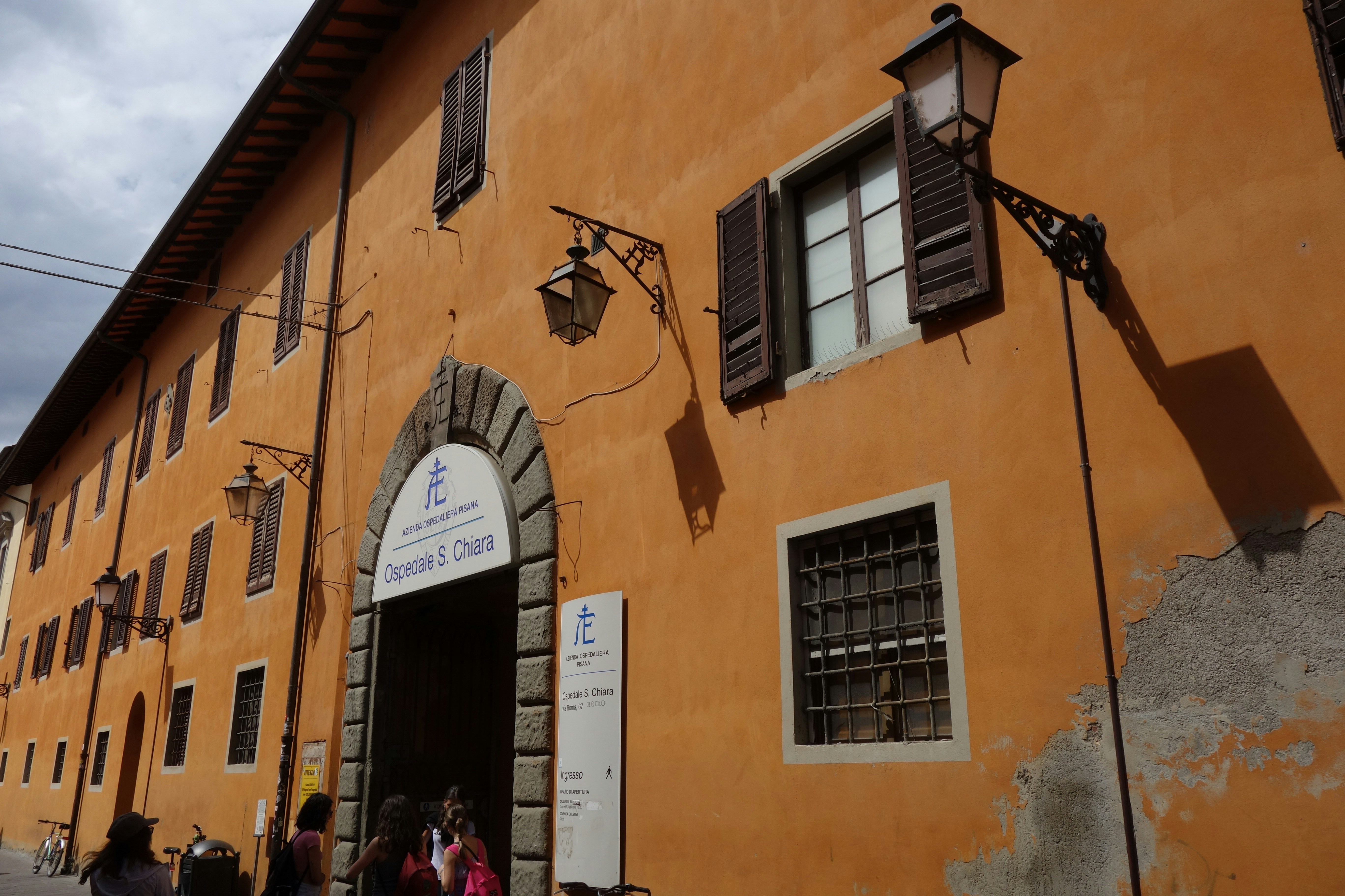 Orange building with arched entrance and windows.