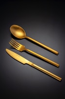 Golden cutlery set on a dark background