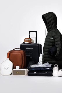 Collection of travel gear and clothing items on-the-go essentials