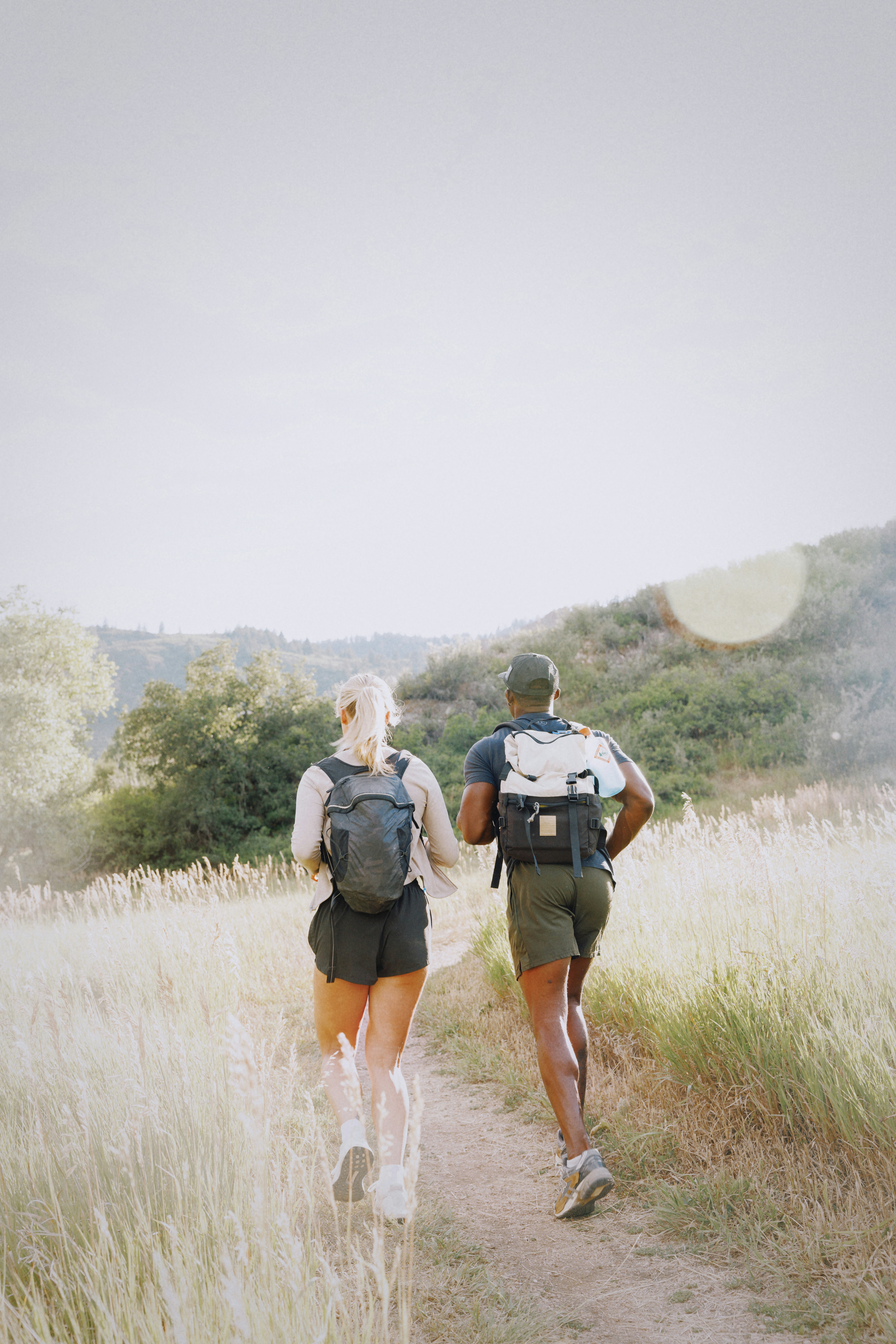 Couple hiking on a sunny trail