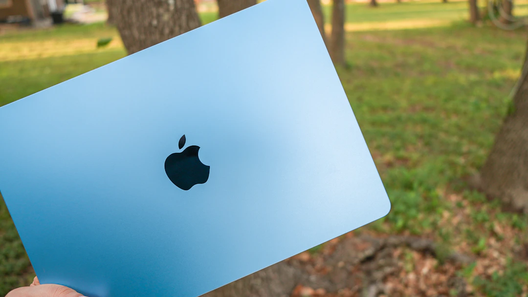 A light blue laptop with an Apple logo