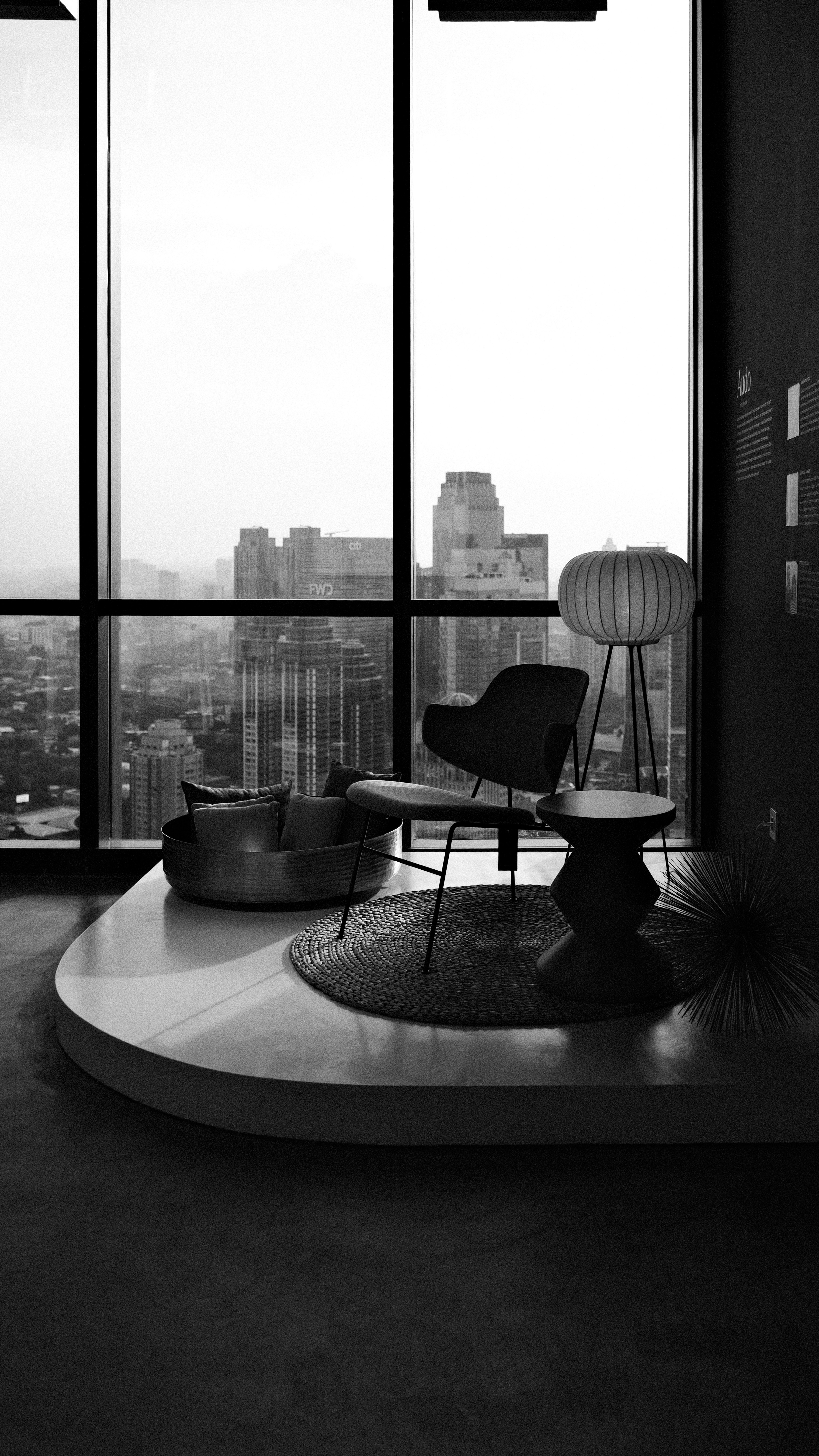 Modern lounge area with city view and furniture.