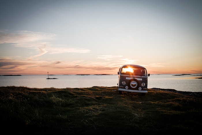 Campervan by the Norwegian coast at sunset