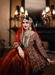 A bride in ornate red and gold attire