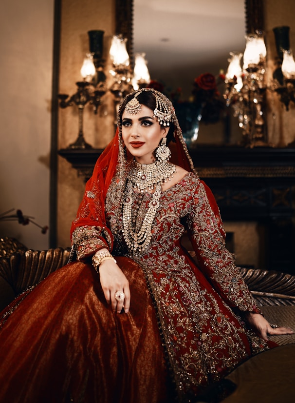 A bride in ornate red and gold attire