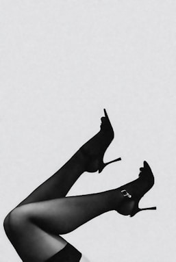 Woman's legs in black high heels and stockings