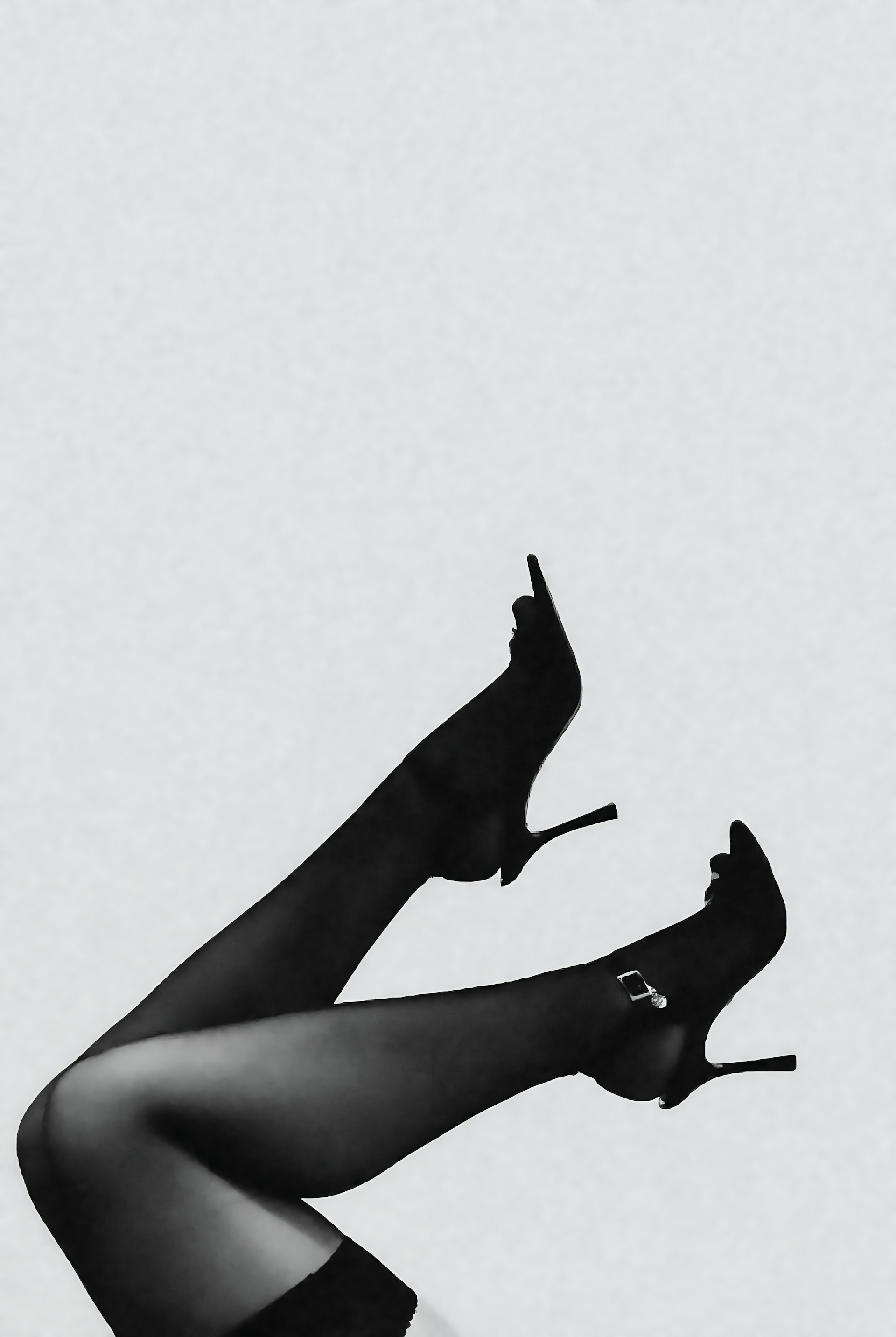 Woman's legs in black high heels and stockings