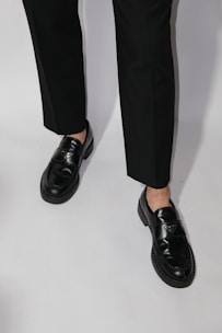 Black loafers with white background