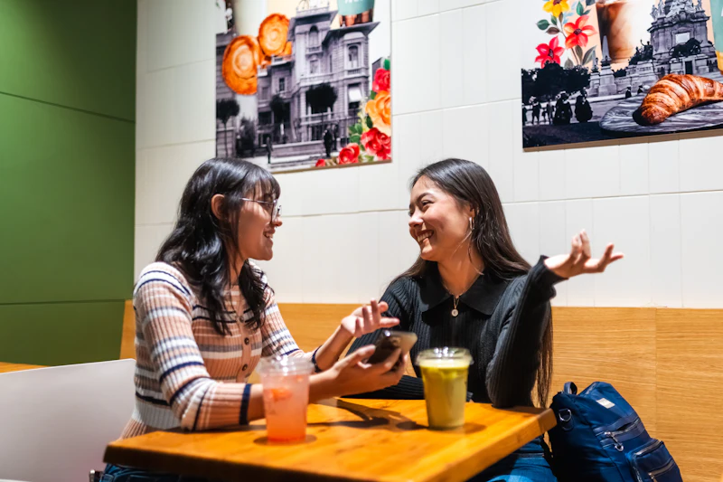 Two people in conversation at a cafe