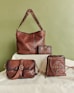 Four brown leather bags and wallets arranged artfully.