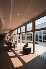 Modern interior with large windows overlooking a zen garden.