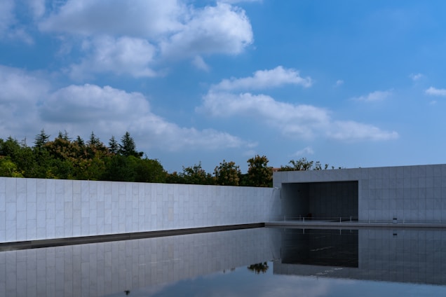 Modern building with reflecting pool and blue sky