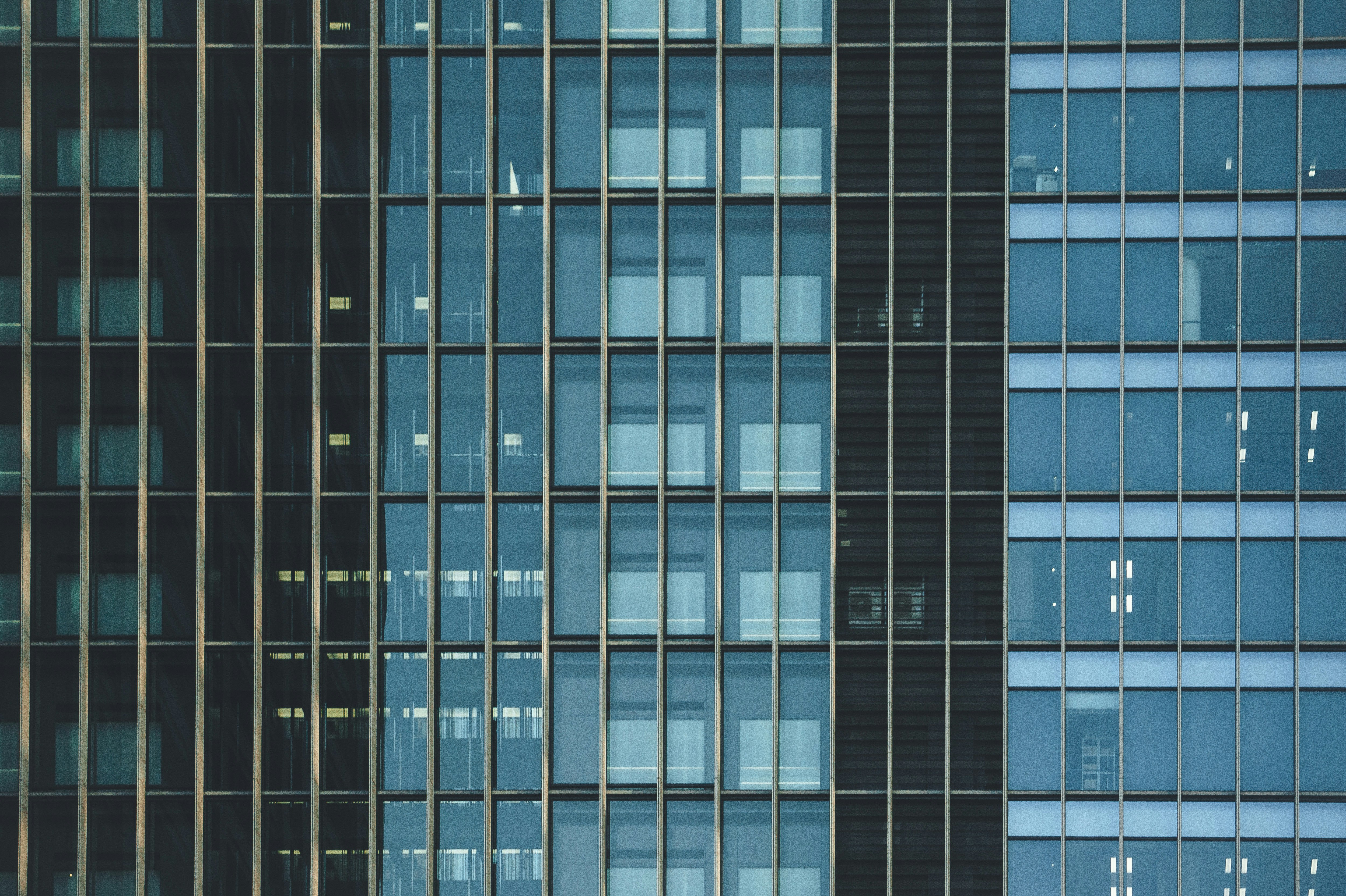 Modern glass skyscraper facade with reflective windows