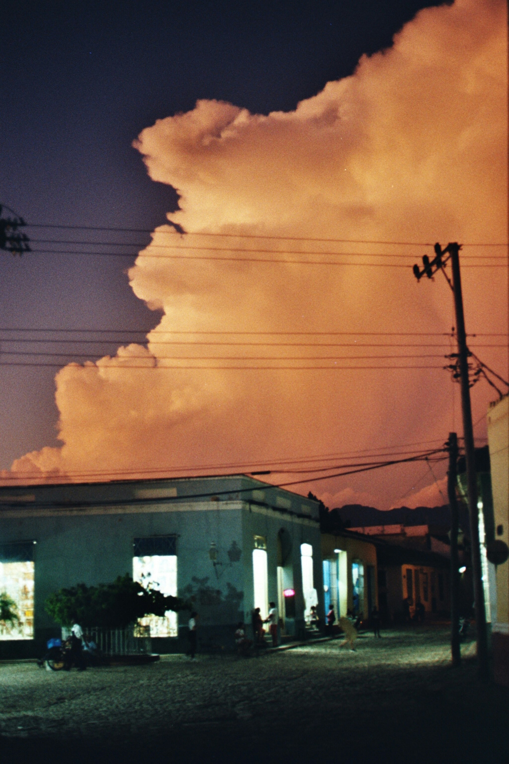 Large cloud formation over buildings at dusk