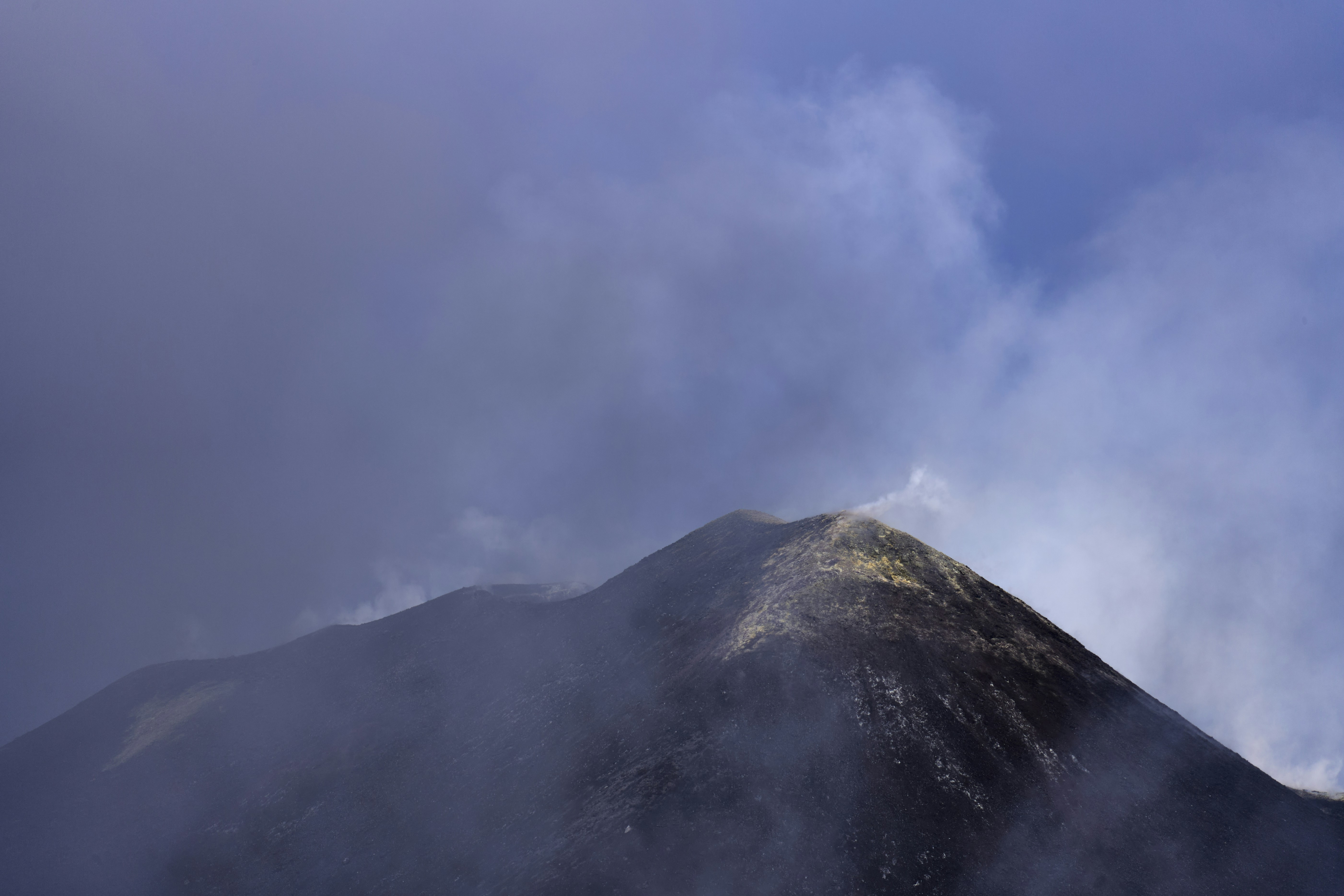Volcano peak shrouded in dramatic clouds