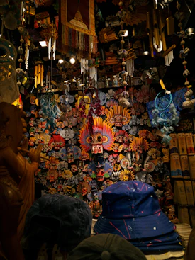 Colorful masks and wind chimes hanging in shop