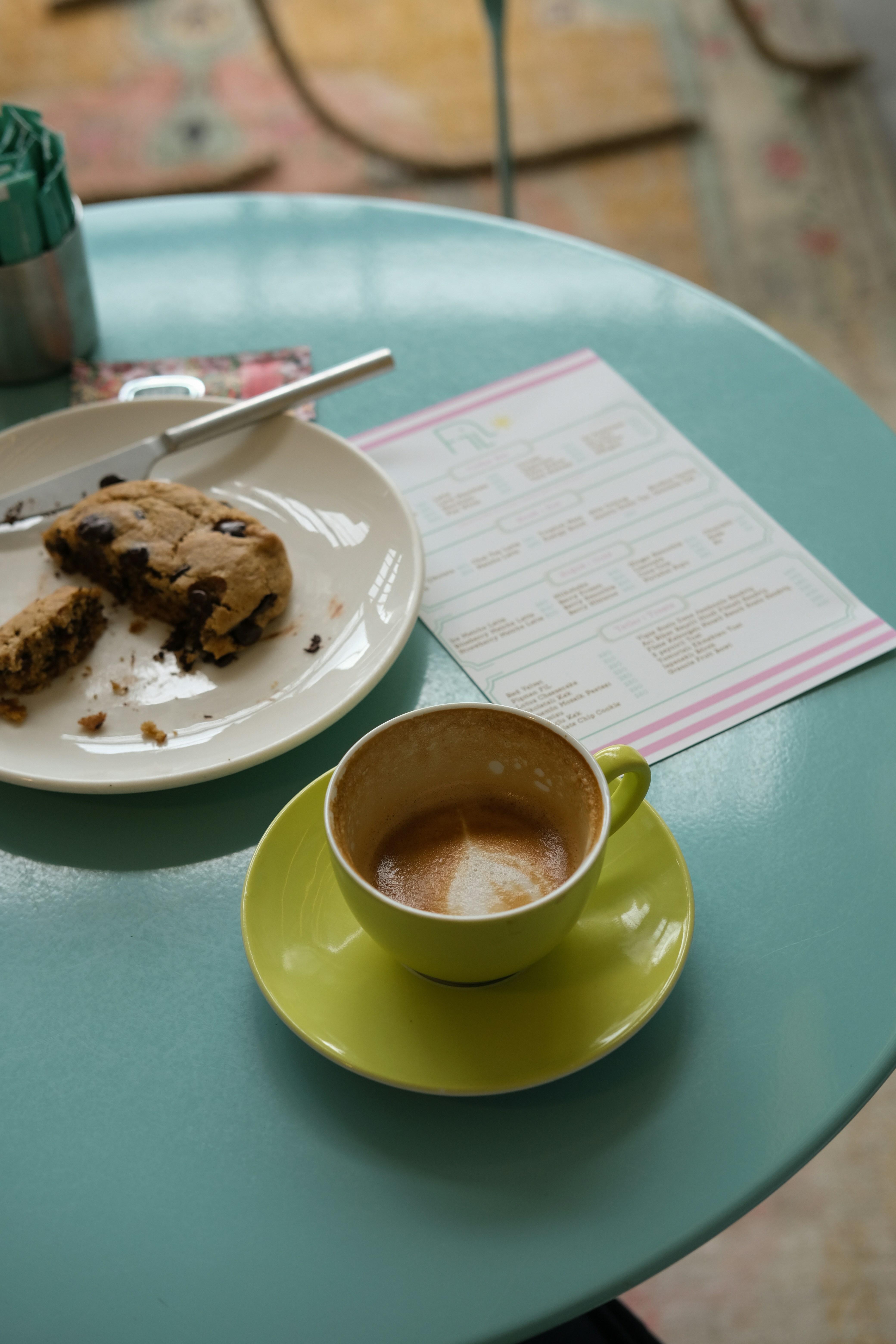 Coffee cup and half-eaten cookie on a table