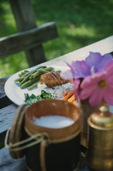 Fried chicken with green beans and salad served outdoors.