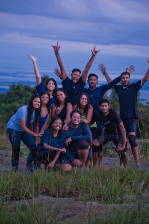 Group of friends celebrating on a hilltop atop a hill