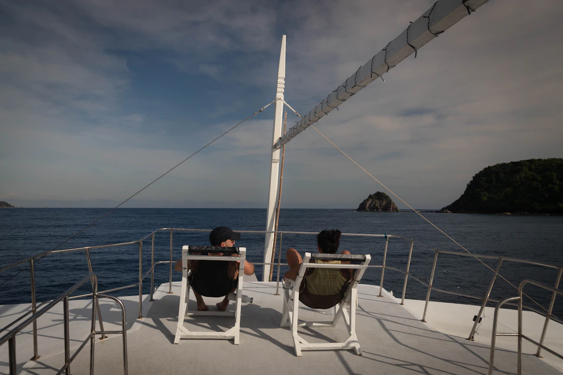 Guests relaxing on the foredeck of a catamaran