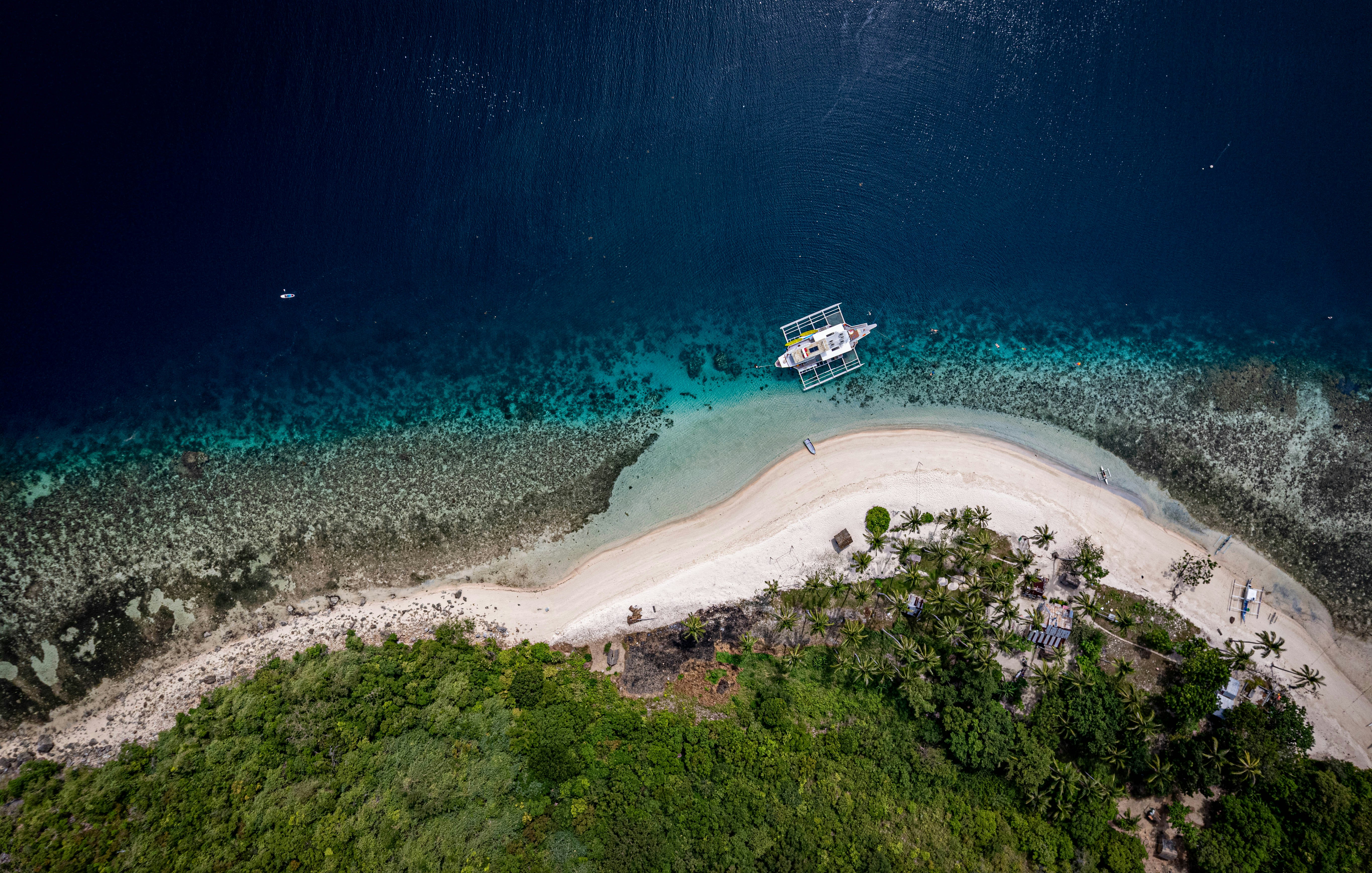 dive boat anchored near a tropical island - da nang scuba diving