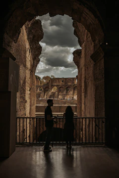Two people looking out from ancient ruins