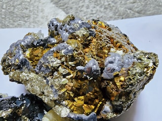 Golden metallic mineral cluster with grey accents