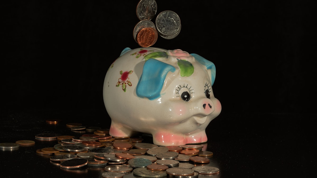 Coins falling into a piggy bank representing Gen Z's early but modest retirement savings