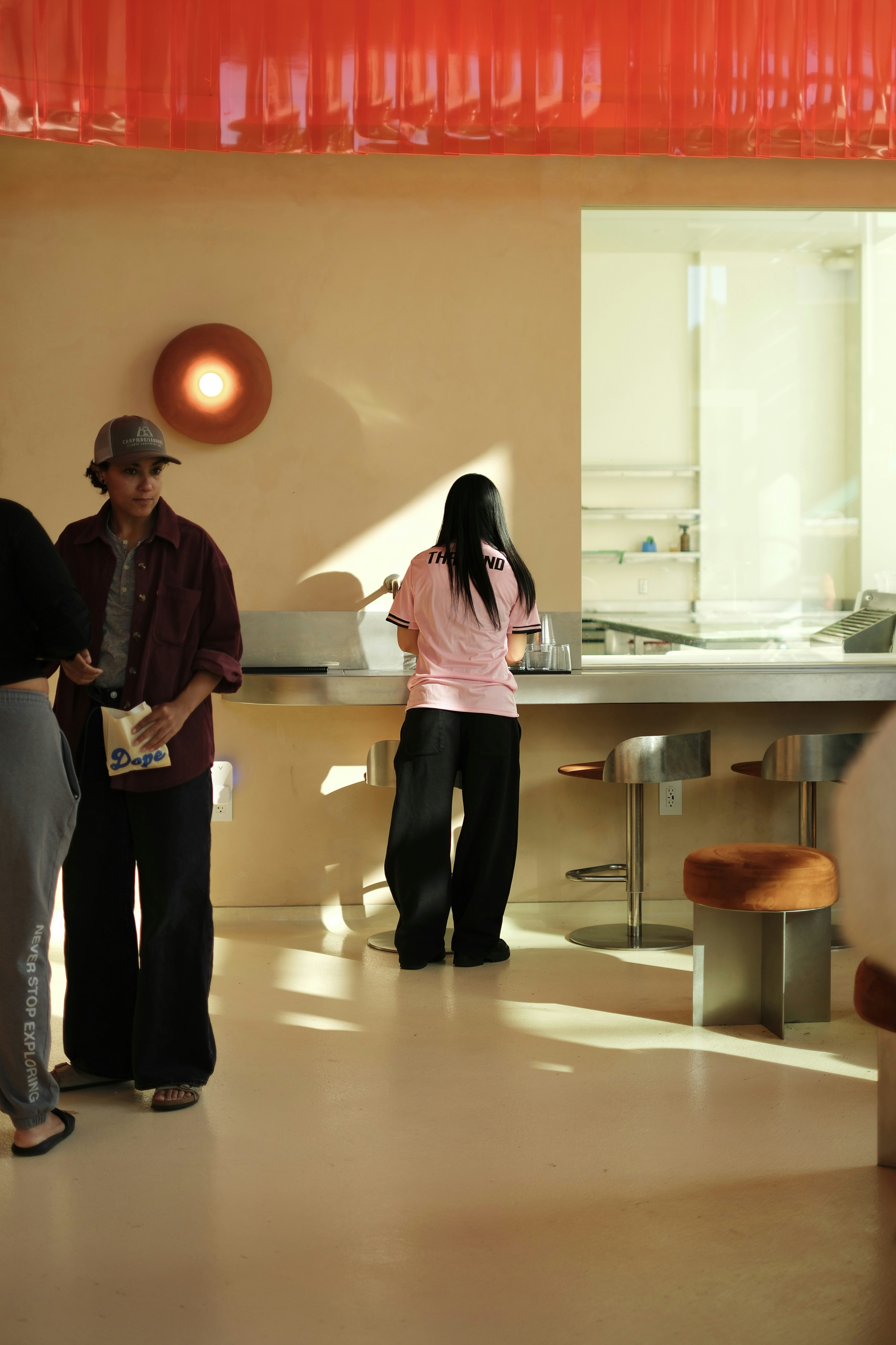 People standing at a counter in a modern space.
