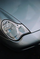 Close-up of a silver car's headlight