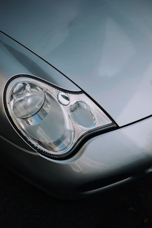 Close-up of a silver car's headlight