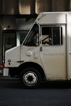 White delivery truck with "the world on time" text.