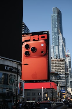 A large billboard displays an iPhone 17 pro advertisement.