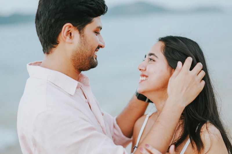STD-aware couple smiling on the beach