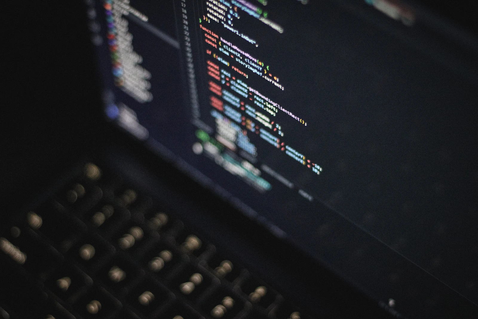 A laptop screen showing colorful programming code