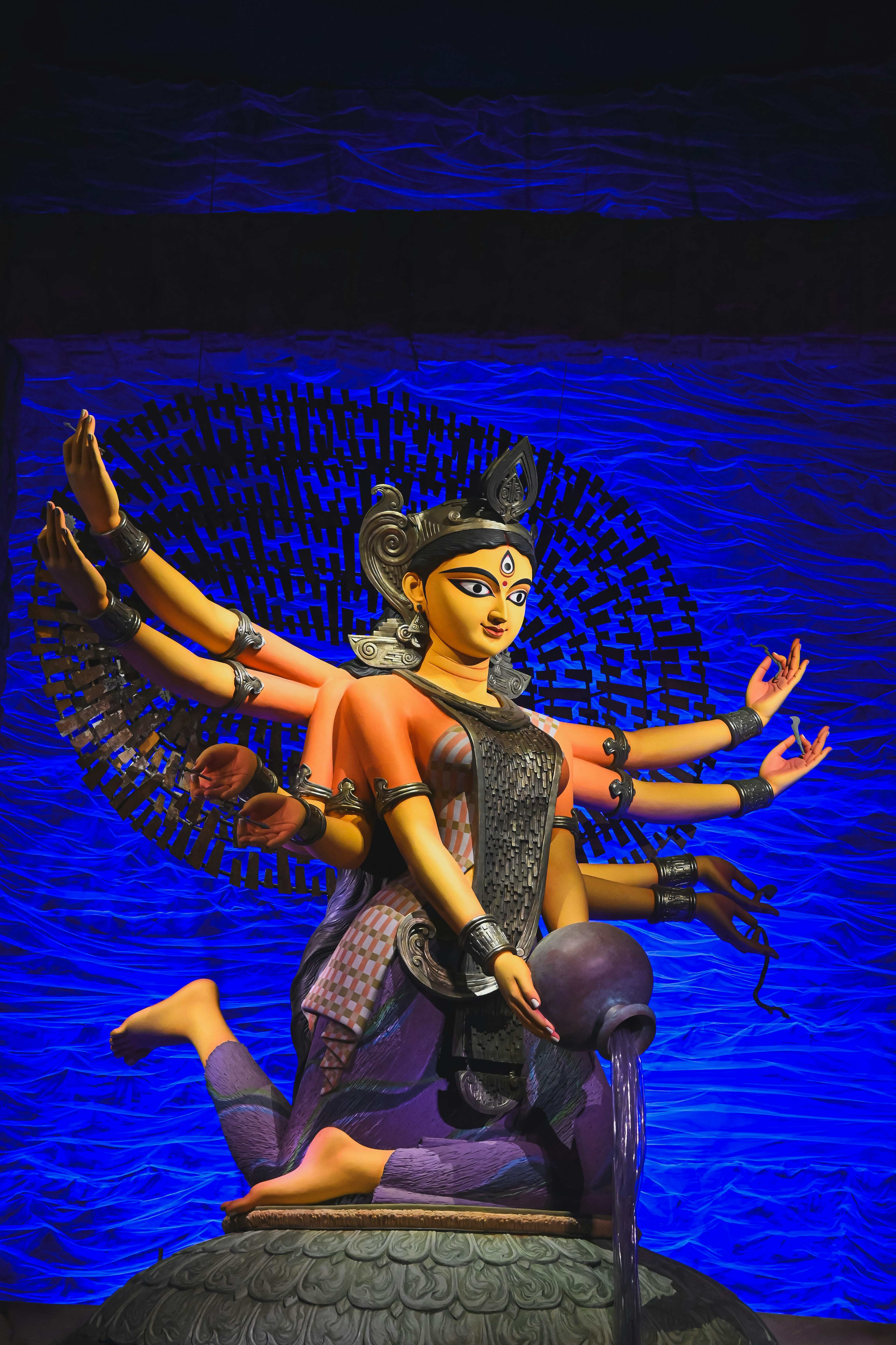 A statue of the hindu goddess durga with multiple arms