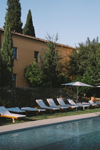Lounge chairs by a swimming pool at a villa.