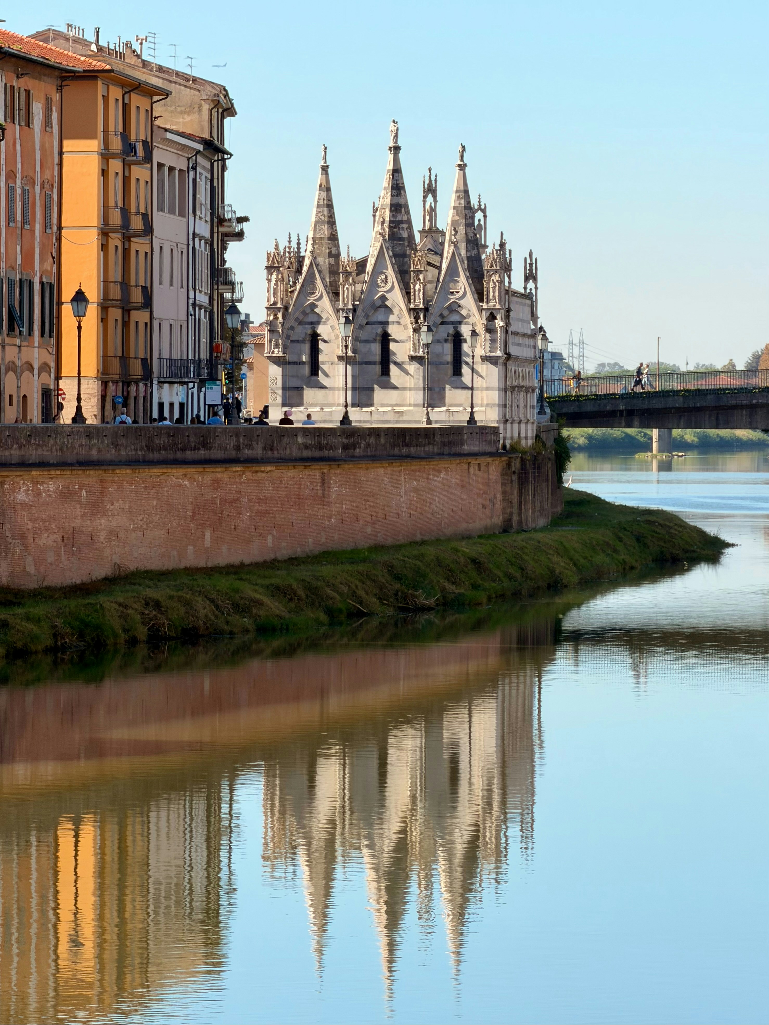 Ornate gothic building reflected in calm river