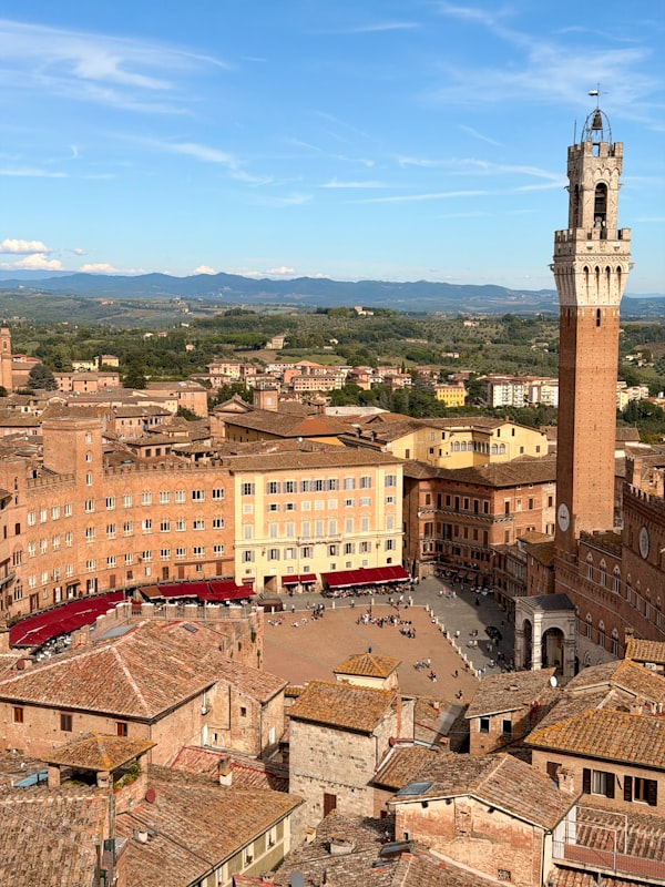 Piazza storica con torre e facciate in mattoni