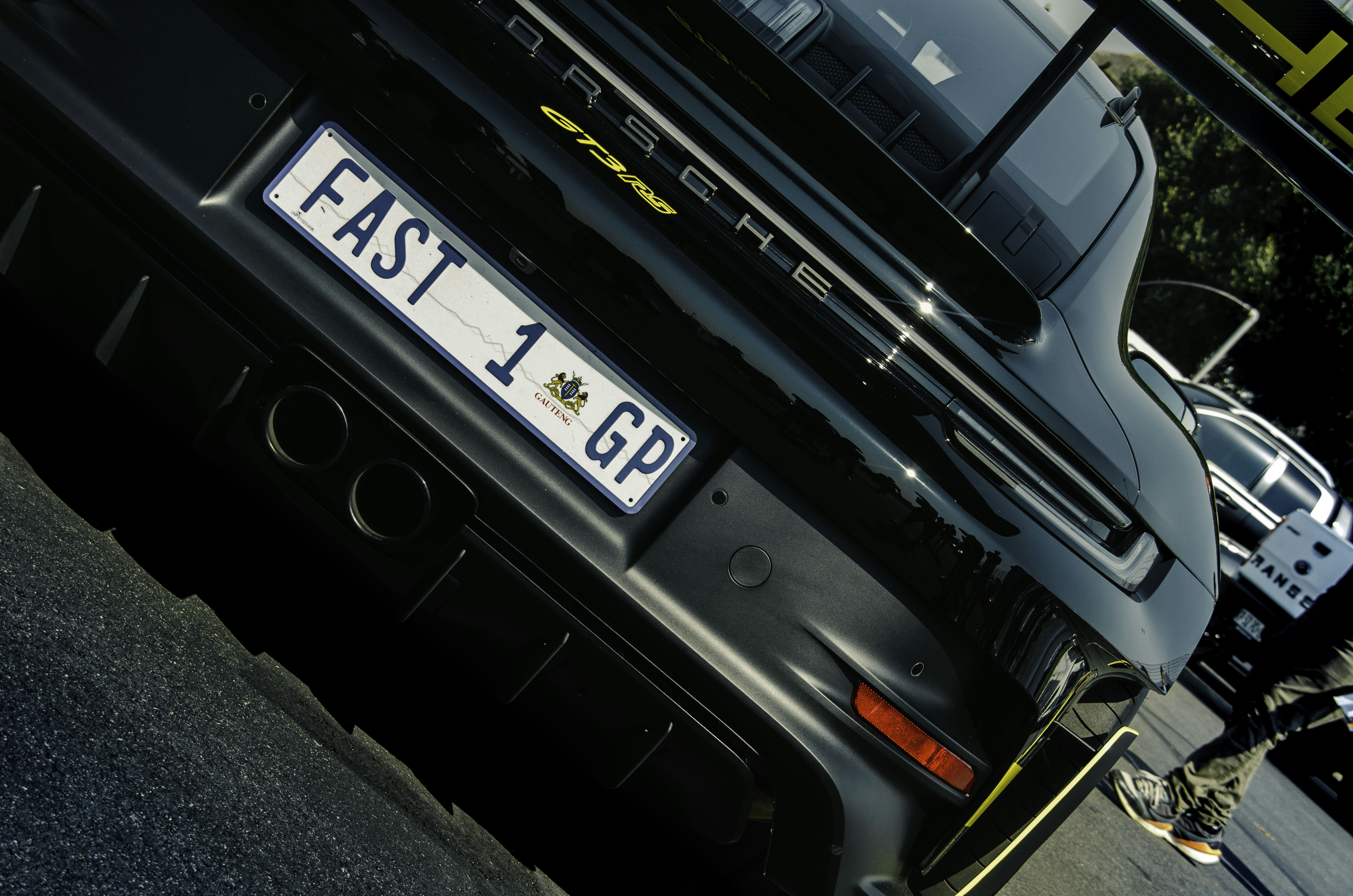 Rear view of a black porsche with custom license plate