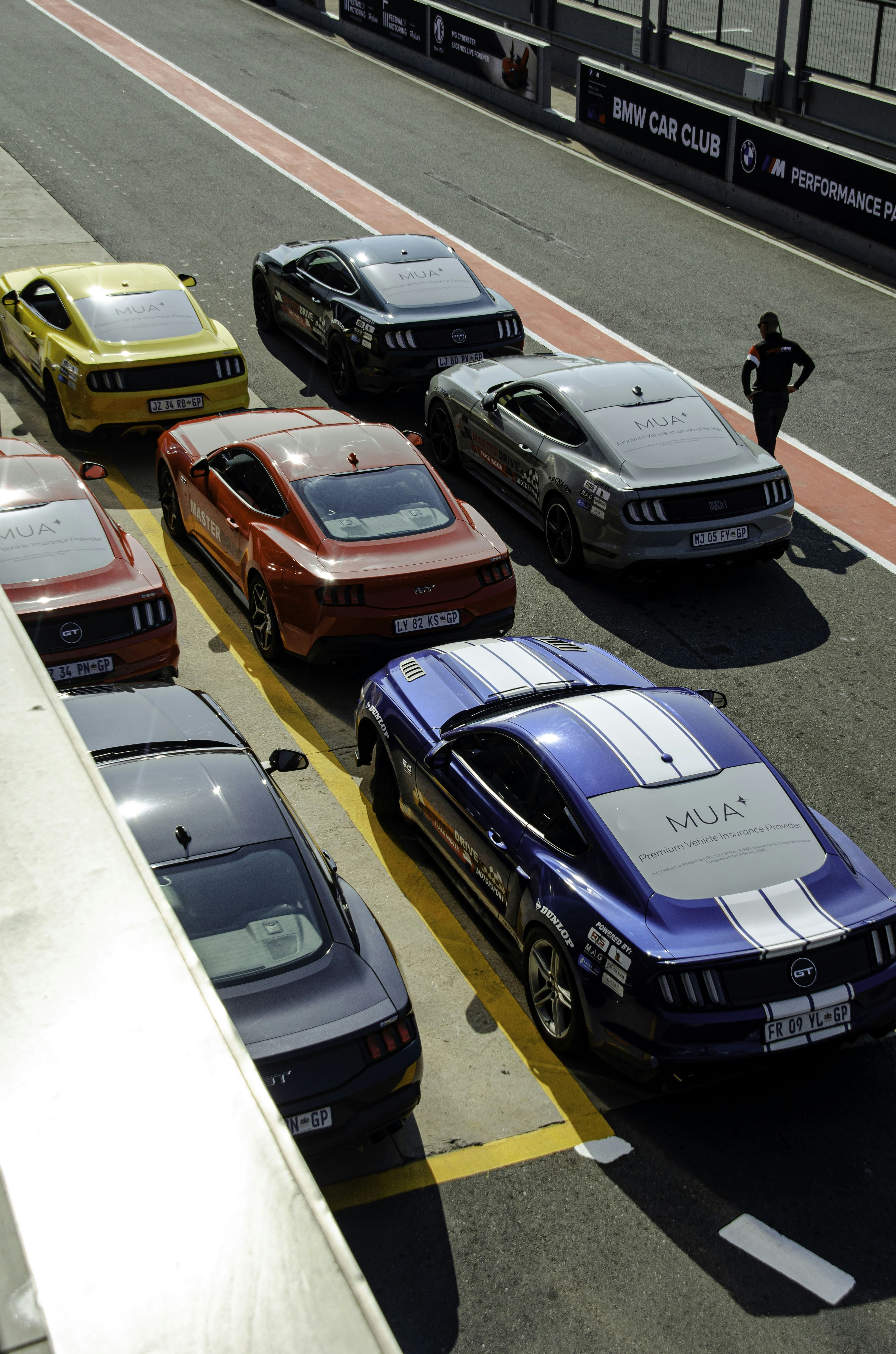 Several ford mustangs parked in a row