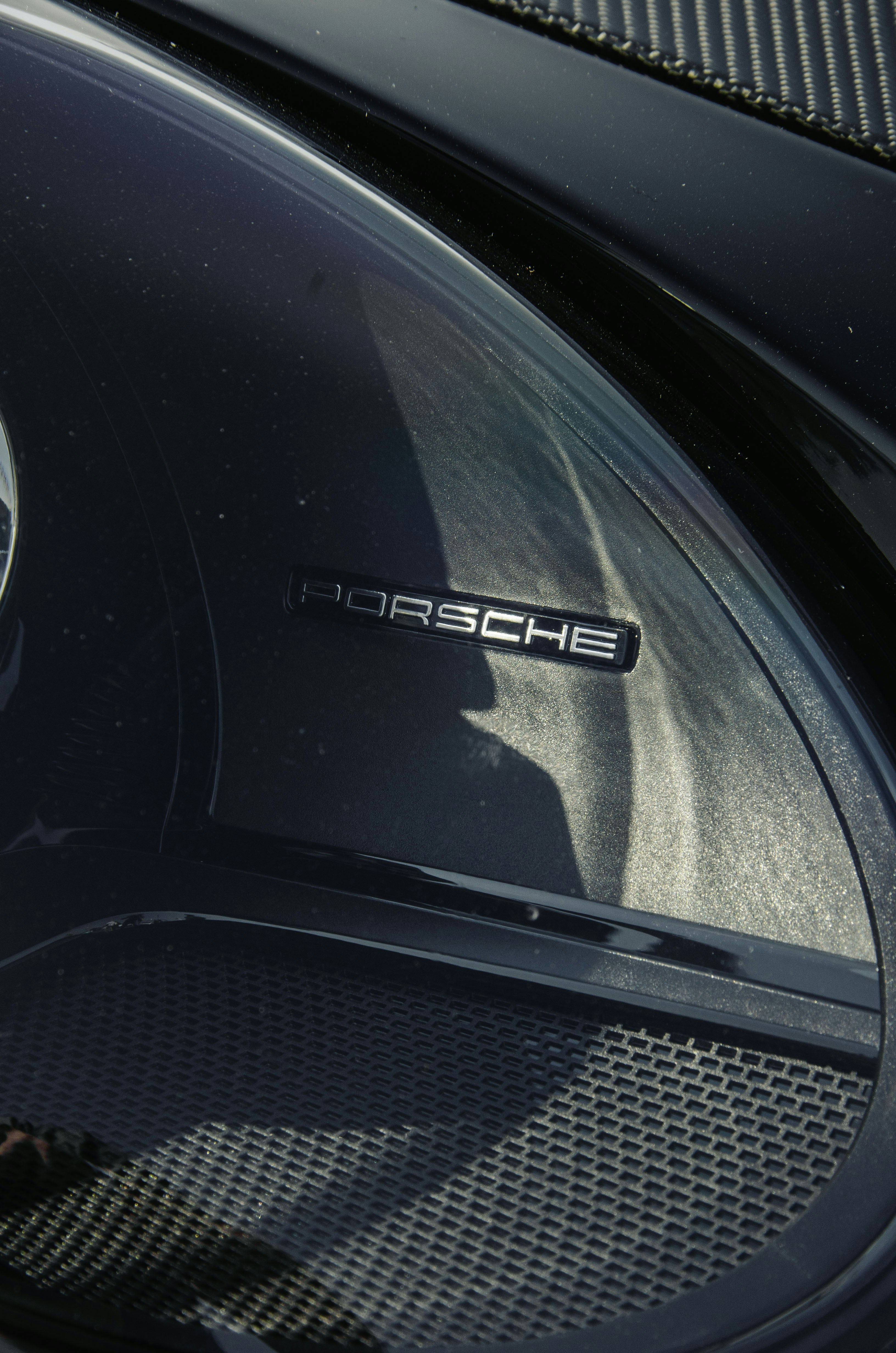 Close-up of a black porsche car emblem
