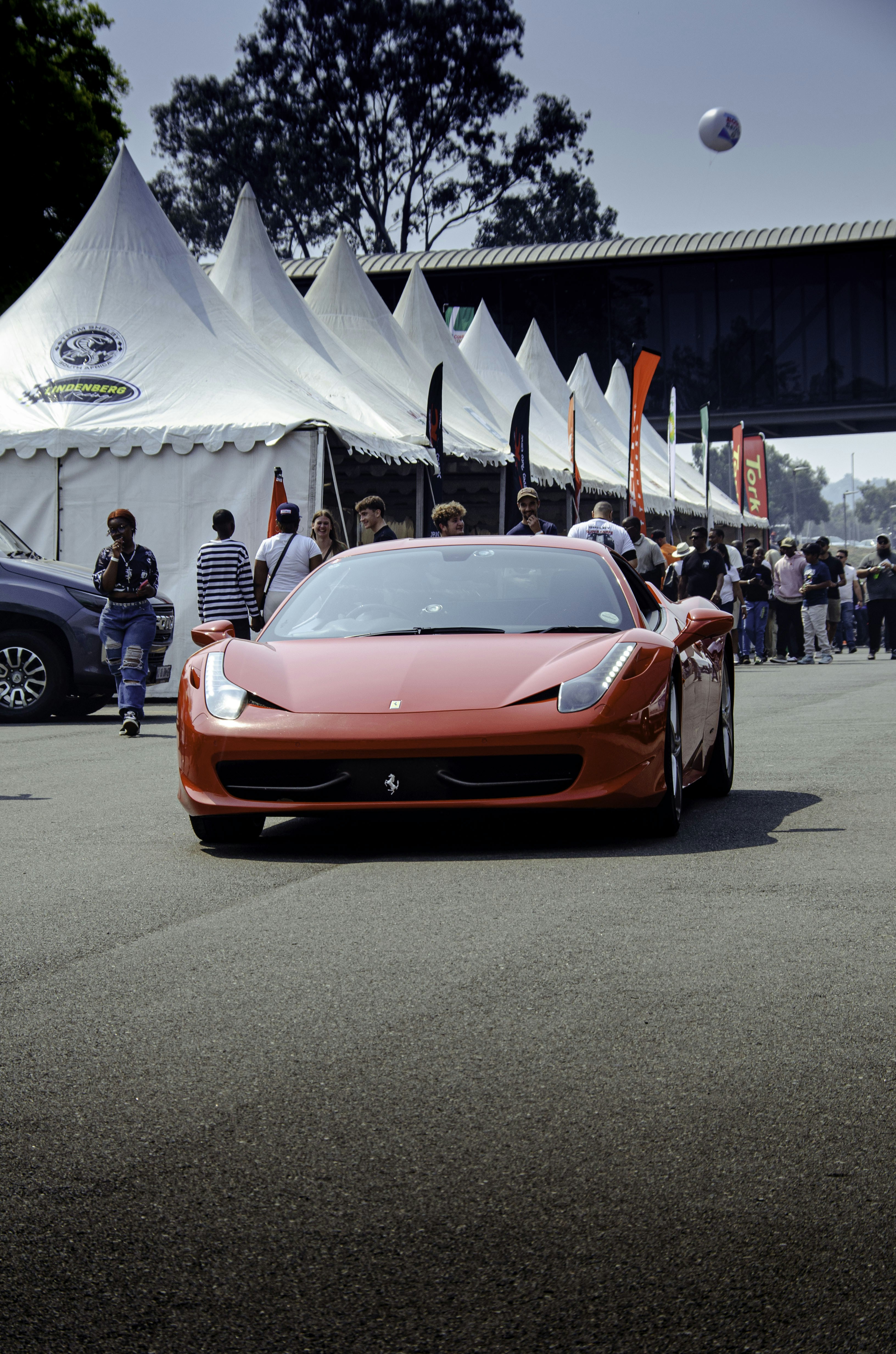 Red sports car driving on a track
